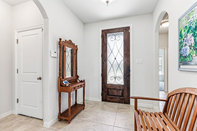 foyer entrance featuring light tile patterned flooring