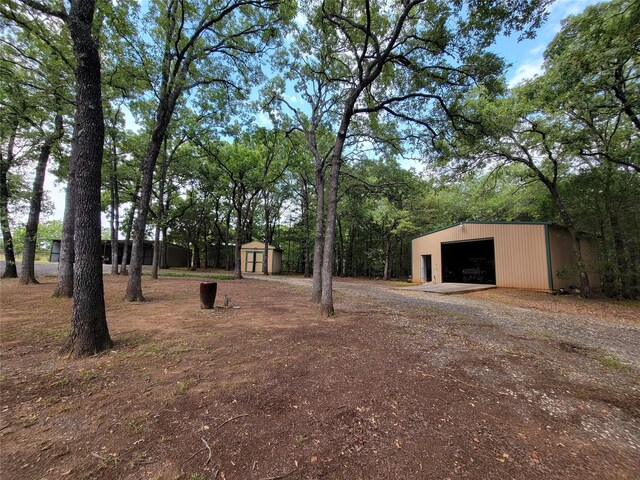 view of yard featuring a shed and a garage