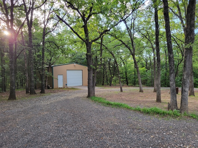 view of front facade featuring a garage and an outbuilding