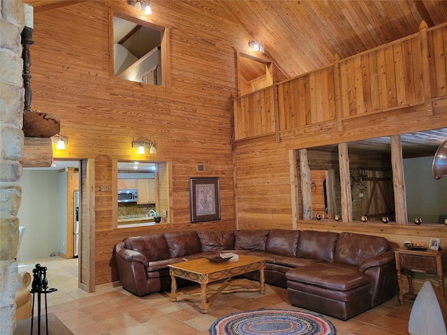 living room featuring high vaulted ceiling, wooden walls, wooden ceiling, and light tile patterned flooring