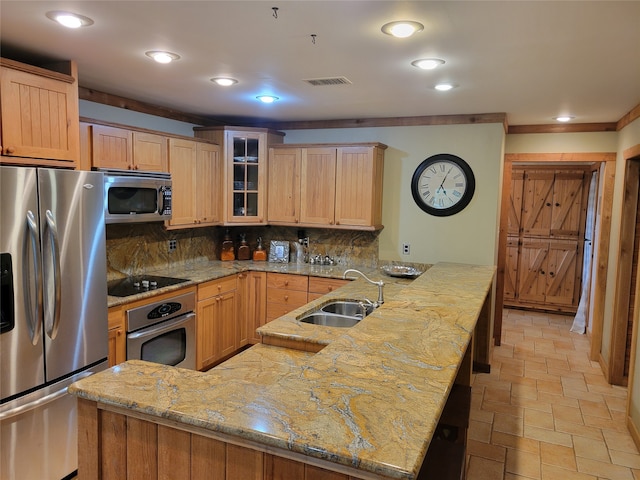 kitchen featuring decorative backsplash, light stone counters, kitchen peninsula, stainless steel appliances, and sink