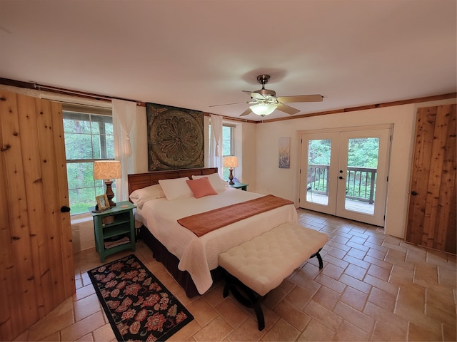 bedroom with multiple windows, ornamental molding, ceiling fan, and access to exterior