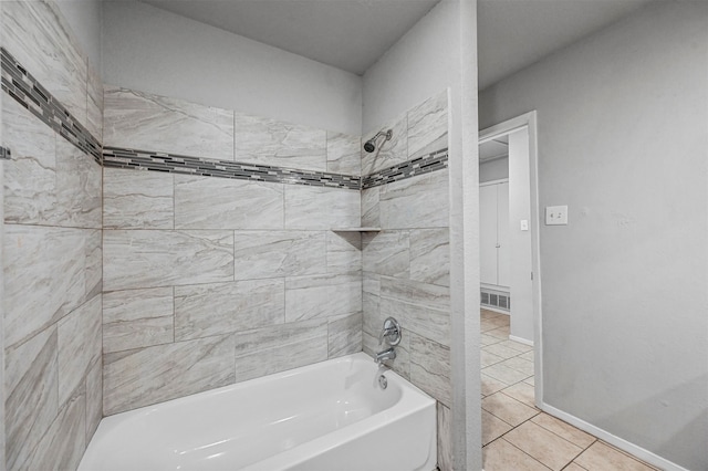 bathroom with tile patterned flooring and tiled shower / bath