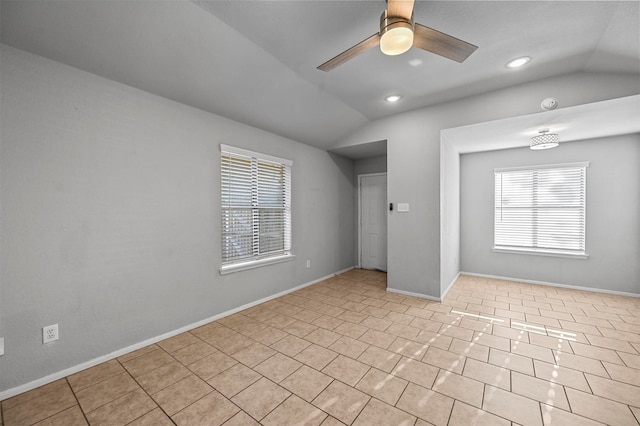 unfurnished living room with vaulted ceiling, ceiling fan, and light tile patterned floors