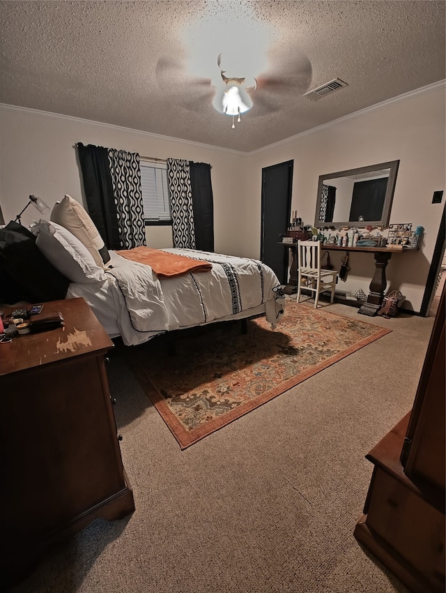 carpeted bedroom with ornamental molding, ceiling fan, and a textured ceiling