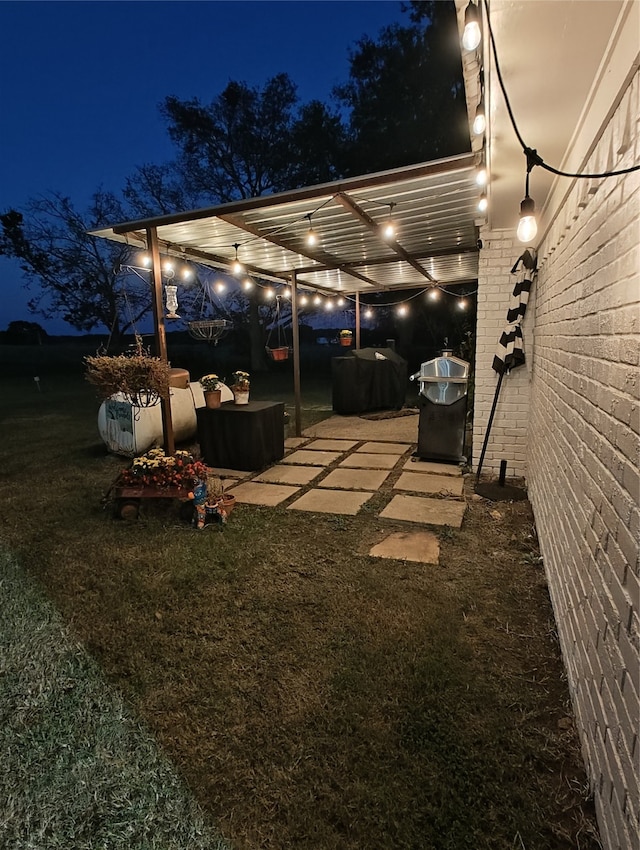 yard at twilight with a pergola and a patio area