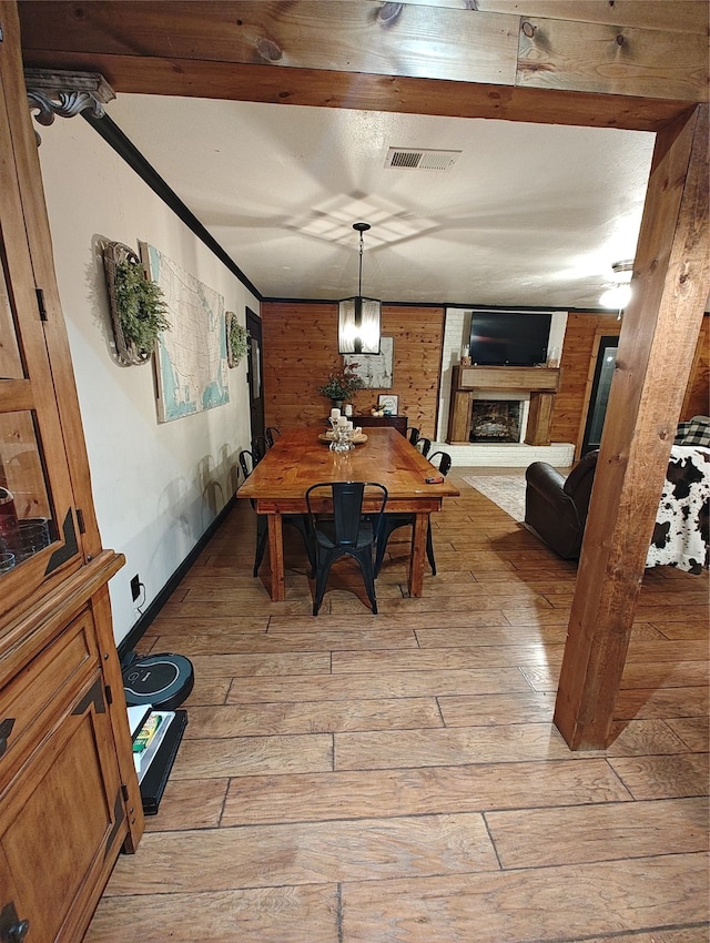 dining area featuring wooden walls and light hardwood / wood-style flooring