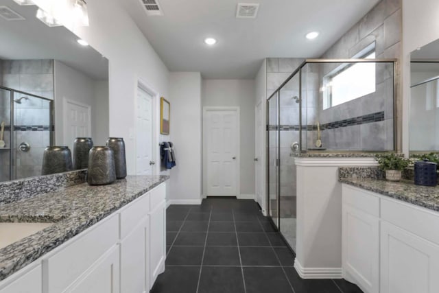 bathroom with vanity, tile patterned flooring, and a shower with door