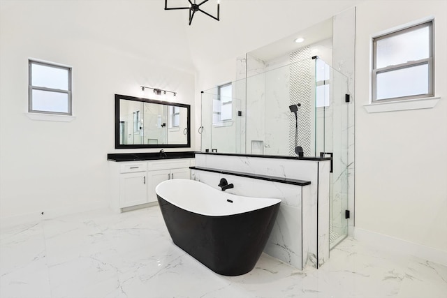 bathroom featuring independent shower and bath, plenty of natural light, and vanity