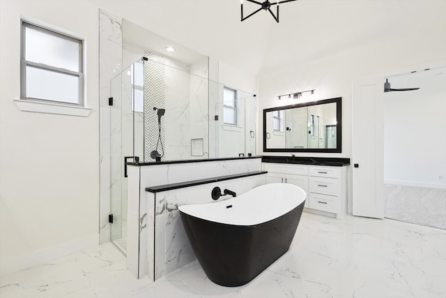 bathroom featuring independent shower and bath, plenty of natural light, and vanity