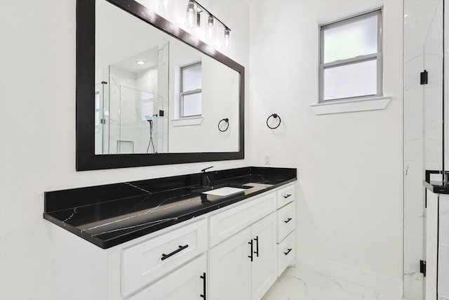 bathroom featuring vanity and a shower with shower door