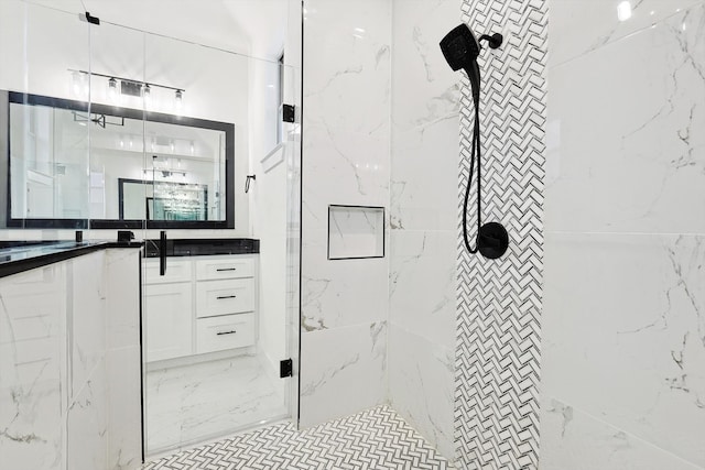 bathroom featuring a tile shower and vanity