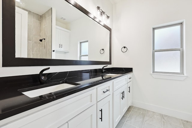 bathroom featuring walk in shower and vanity