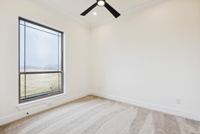 carpeted empty room with crown molding and ceiling fan