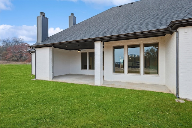 rear view of property with a lawn and a patio area