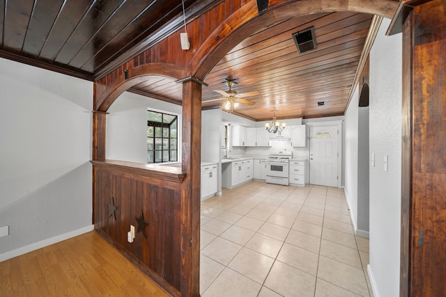 kitchen with white stove, ceiling fan with notable chandelier, white cabinetry, crown molding, and wooden ceiling