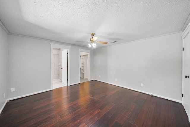 unfurnished bedroom featuring a closet, a textured ceiling, wood-type flooring, ceiling fan, and a walk in closet