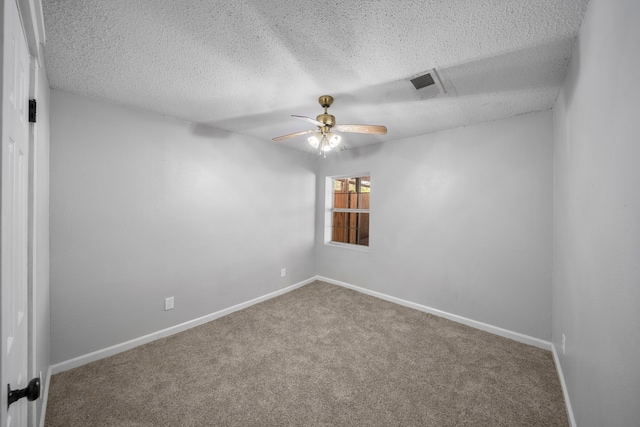 unfurnished room with a textured ceiling, ceiling fan, and carpet floors