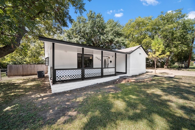 view of front of home featuring a front yard and central air condition unit