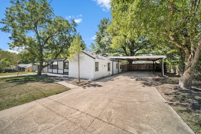 view of front of house with a front yard and a carport