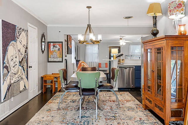 dining space featuring ornamental molding, ceiling fan with notable chandelier, and dark wood-type flooring