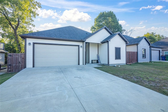 ranch-style home featuring a front yard and a garage