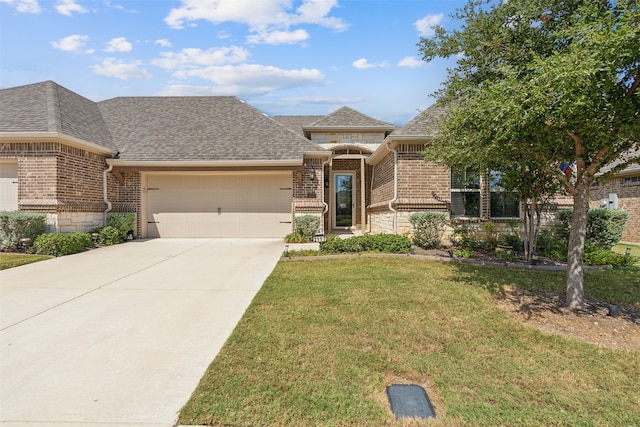 view of front of house with a front lawn and a garage