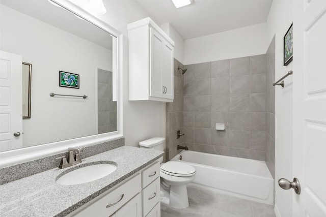 full bathroom featuring tile patterned floors, tiled shower / bath, vanity, and toilet