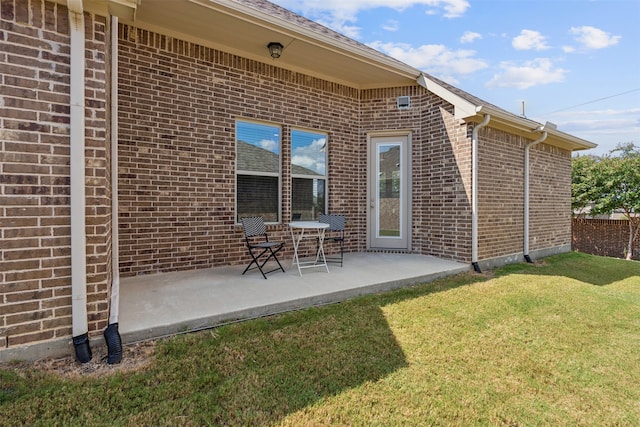 rear view of property with a yard and a patio