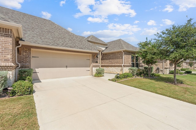 view of front facade featuring a garage and a front lawn