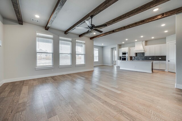 4025 Lagos Dr, Midlothian, TX 76065 - unfurnished living room featuring ceiling fan, beam ceiling, light wood-style floors, and recessed lighting