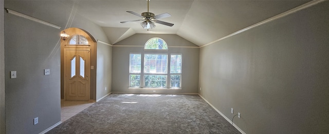 carpeted foyer entrance featuring ceiling fan and vaulted ceiling