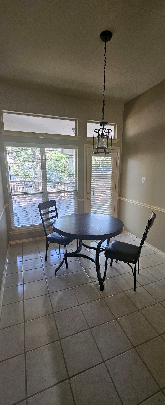 dining space with tile patterned flooring