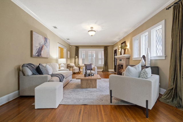 living room with crown molding, a fireplace, and dark wood-type flooring