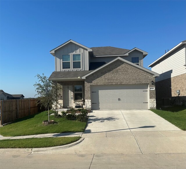 view of front of property with a garage and a front lawn