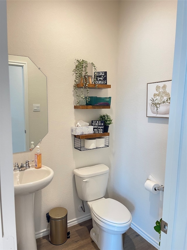 bathroom featuring sink, hardwood / wood-style flooring, and toilet