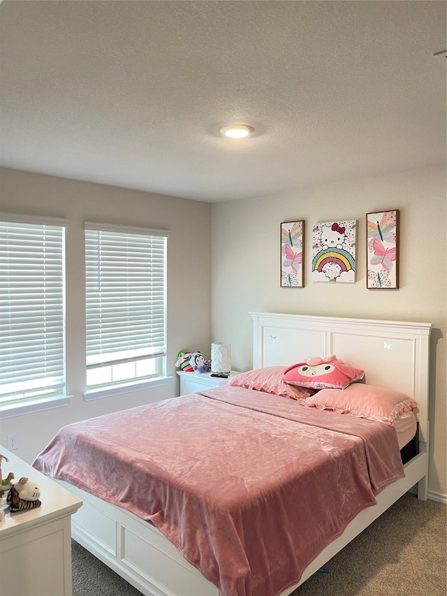 carpeted bedroom featuring a textured ceiling