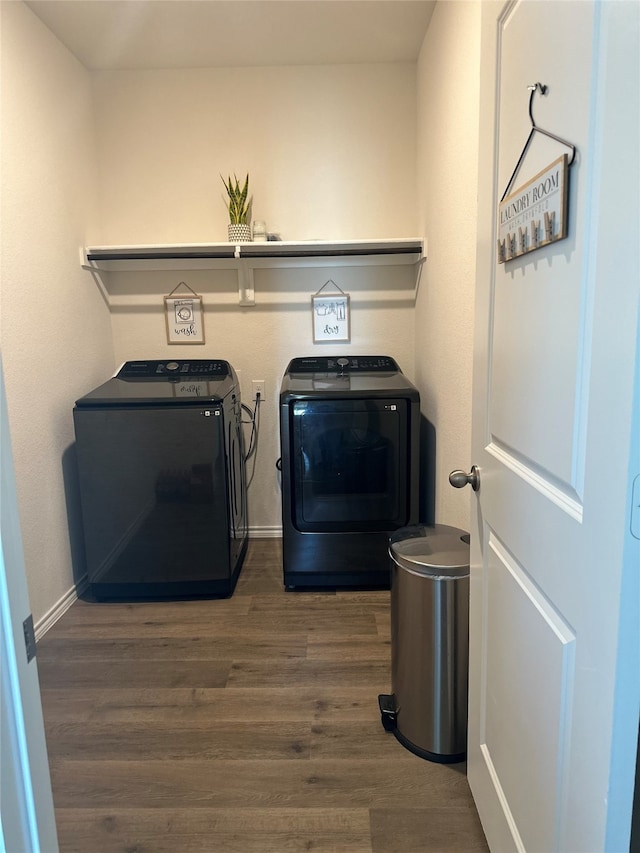 laundry room with washing machine and dryer and dark wood-type flooring