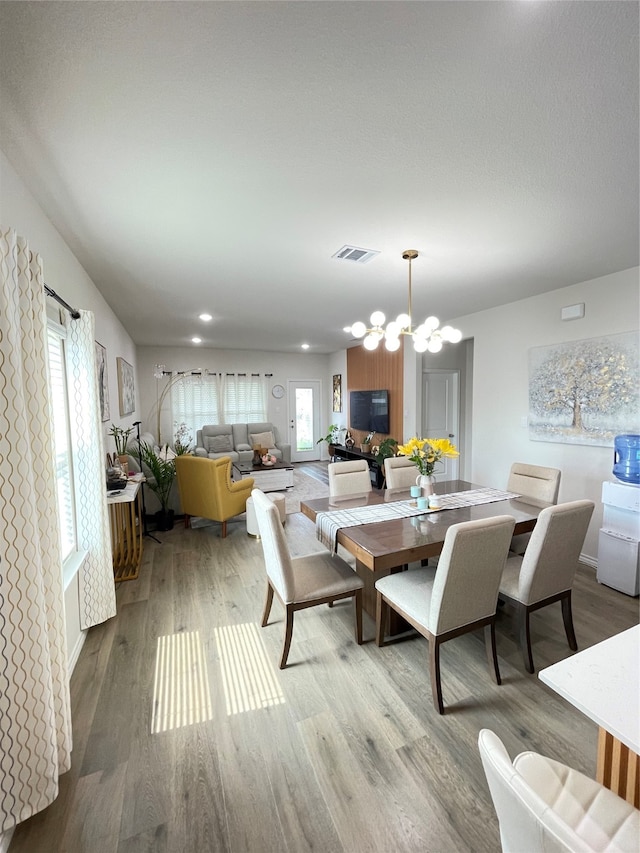 dining room with a notable chandelier and light hardwood / wood-style floors