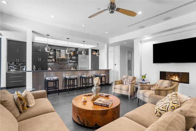 living room featuring dark hardwood / wood-style flooring and ceiling fan