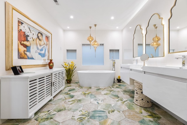 bathroom featuring a tub to relax in and vanity