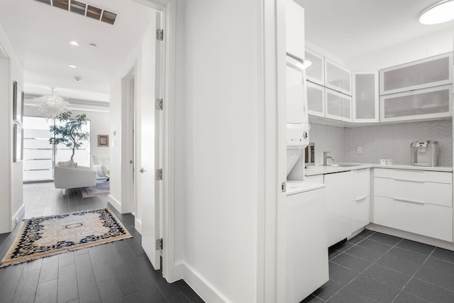 interior space featuring white cabinets, dark hardwood / wood-style floors, and sink