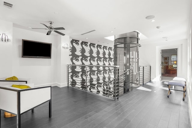 interior space with ceiling fan and dark wood-type flooring