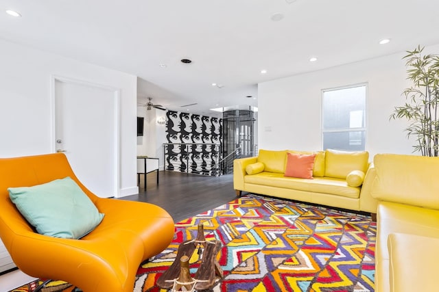 living room with wood-type flooring and ceiling fan