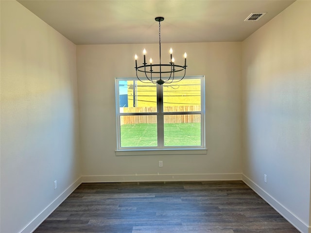 unfurnished dining area with dark hardwood / wood-style flooring and a notable chandelier