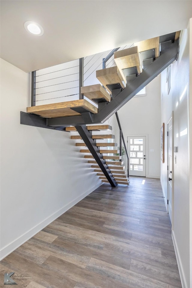 stairway featuring baseboards and wood finished floors