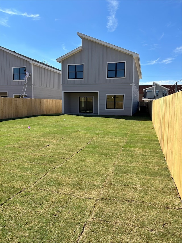 back of property with a lawn