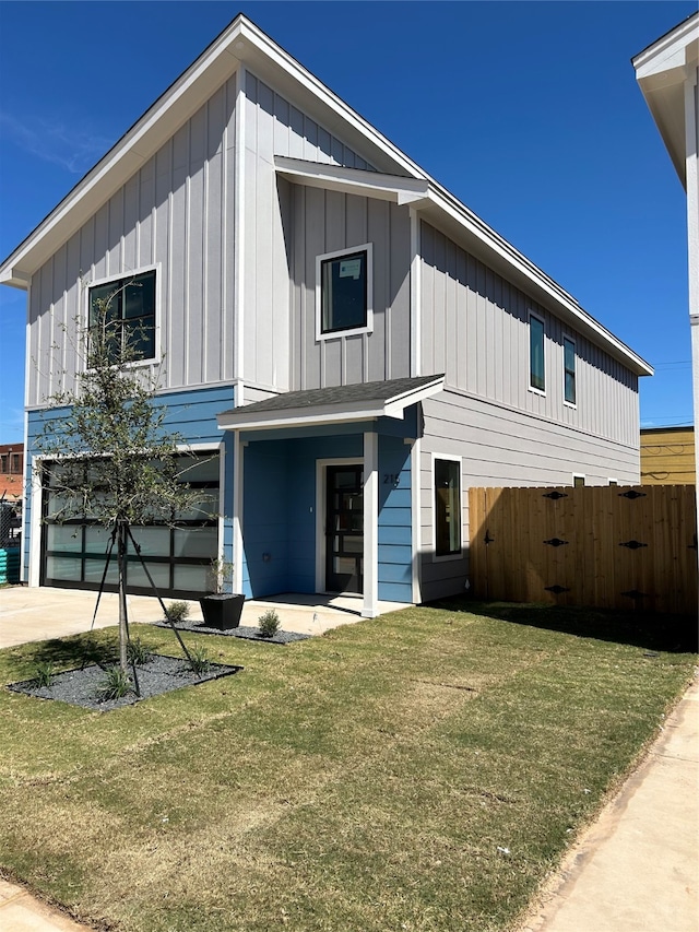 view of front of property featuring a garage and a front yard