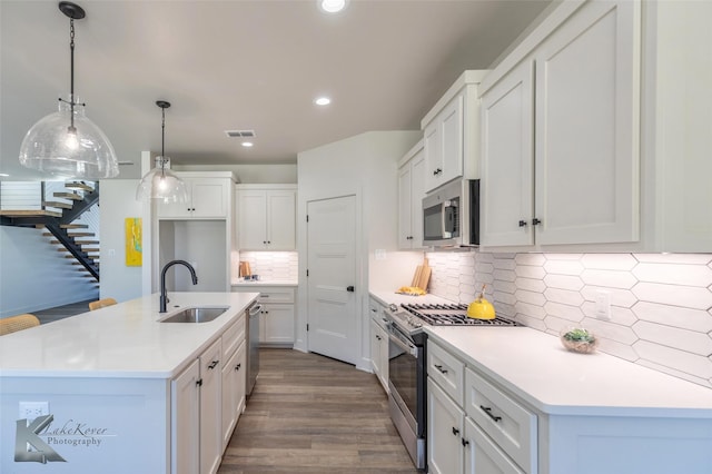 kitchen with stainless steel appliances, recessed lighting, visible vents, white cabinets, and a sink