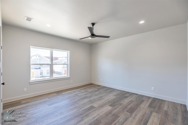 spare room featuring ceiling fan, recessed lighting, wood finished floors, visible vents, and baseboards